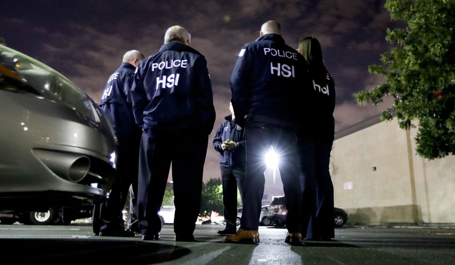 FILE - In this Jan. 10, 2018, file photo U.S. Immigration and Customs Enforcement agents gather before serving a employment audit notice at a 7-Eleven convenience store in Los Angeles. Immigration officials have sharply increased audits of companies to verify that their employees are authorized to work in the country, signaling the Trump administration's crackdown on illegal immigration is reaching deeper into the workplace to create a "culture of compliance" among employers who rely on immigrant labor. (AP Photo/Chris Carlson, File)