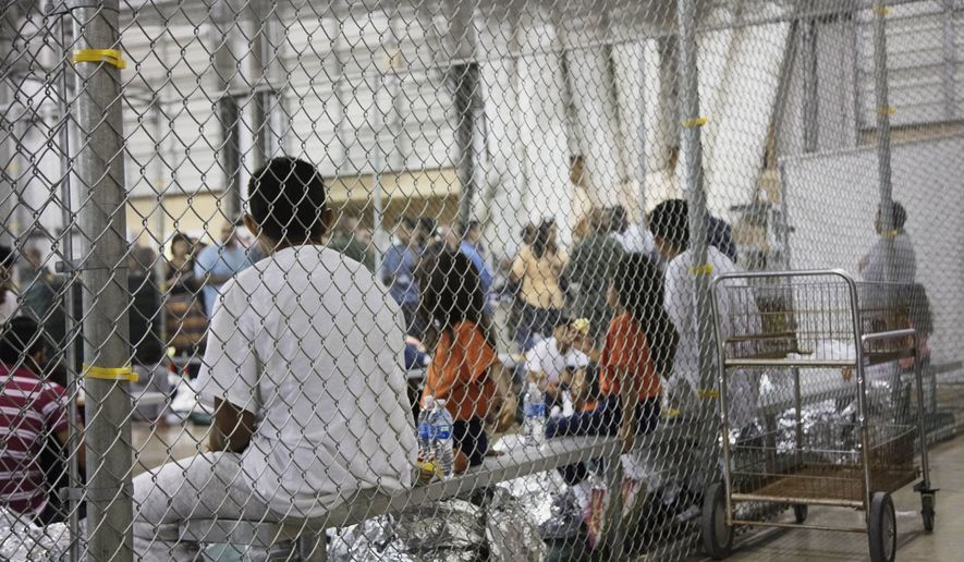 In this photo provided by U.S. Customs and Border Protection, people who&#x27;ve been taken into custody related to cases of illegal entry into the United States, sit in one of the cages at a facility in McAllen, Texas, Sunday, June 17, 2018. (U.S. Customs and Border Protection&#x27;s Rio Grande Valley Sector via AP)