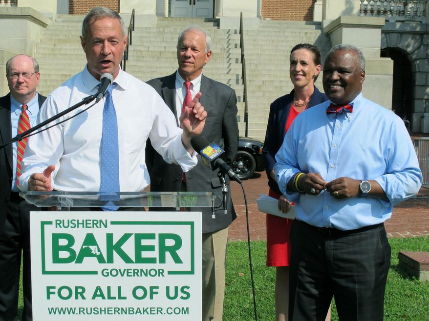 FILE - In this June 7, 2018 file photo, former Gov. Martin O'Malley, front left, endorses Prince George's County Executive Rushern Baker, right, for governor of Maryland, in Annapolis, Md. With two leading candidates who have a shot at becoming Maryland’s first black governor, the crowded Democratic gubernatorial primary reflects the state’s changing demographics and the party’s efforts to harness the energy of an increasingly diverse electorate around the country. Recent polls show former NAACP President Ben Jealous and Baker are leading in a close and crowded primary. (AP Photo/Brian Witte, File)