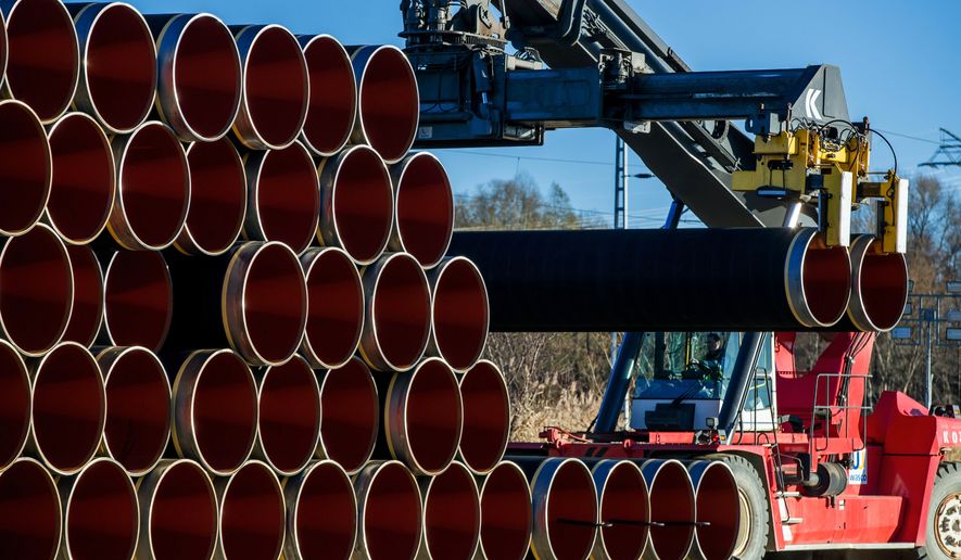 A special crane stacks pipes weighing several tons each which will be used for the construction of the Nord Stream gas pipeline in the Sassnitz-Mukran harbour in northeastern Germany, 06 December 2016. The first sections of the 1,200 kilometer pipeline were delivered in late October 2016. Around 2,000 of a total 90,000 steal pipe components are currently being stored on the island of Ruegen. According to the Gazprom subsidiary Nord Stream 2 AG, work will begin in mid-2017. So far the politically controversial pipeline, which will have a total capacity of some 55 billion cubic meters, has not recieved building permission. Photo by: Jens Büttner/picture-alliance/dpa/AP Images