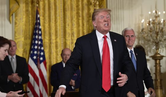 President Donald Trump speaks as he stands up after signing a space policy directive during a National Space Council meeting in the East Room of the White House in Washington, Monday, June 18, 2018. Vice President Mike Pence watches at right. (AP Photo/Susan Walsh)