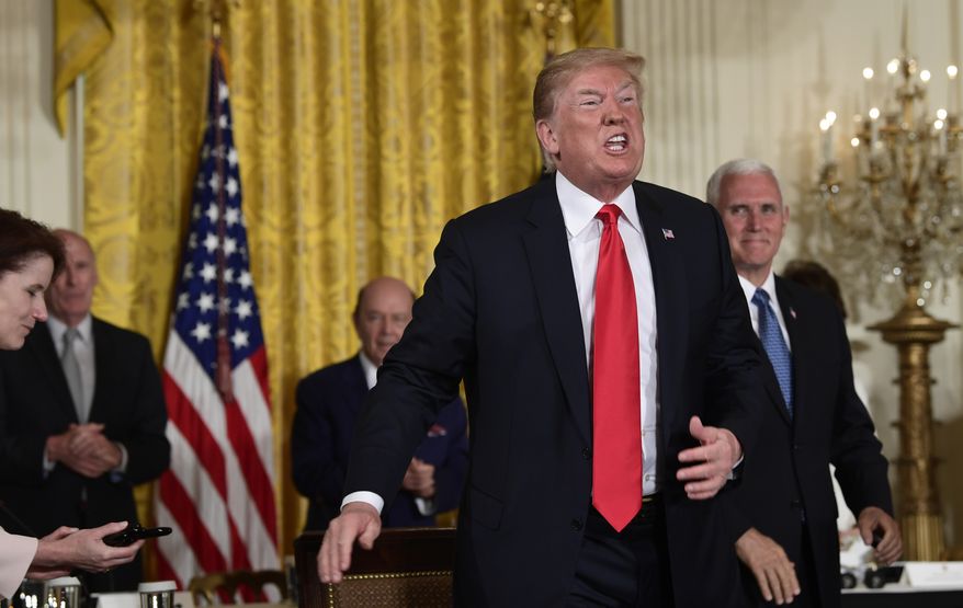 President Donald Trump speaks as he stands up after signing a space policy directive during a National Space Council meeting in the East Room of the White House in Washington, Monday, June 18, 2018. Vice President Mike Pence watches at right. (AP Photo/Susan Walsh)
