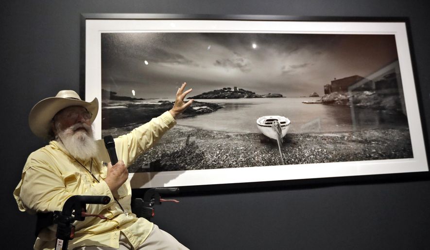 Clyde Butcher gestures as he gives a description of one of his photographs during the opening of his &amp;quot;Clyde Butcher, Visions of Dali&#x27;s Spain&amp;quot; exhibit, at the Salvador Dali Museum Friday, June 15, 2018, in St. Petersburg, Fla. The new exhibit features photographs of the places in Spain where Dali lived, shot by Butcher, a photographer renowned for his pictures of the Florida Everglades. (AP Photo/Chris O&#x27;Meara)
