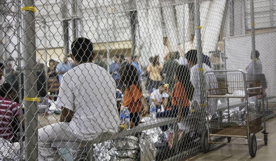 In this photo provided by U.S. Customs and Border Protection, people who&#39;ve been taken into custody related to cases of illegal entry into the United States, sit in one of the cages at a facility in McAllen, Texas, Sunday, June 17, 2018. (U.S. Customs and Border Protection&#39;s Rio Grande Valley Sector via AP)