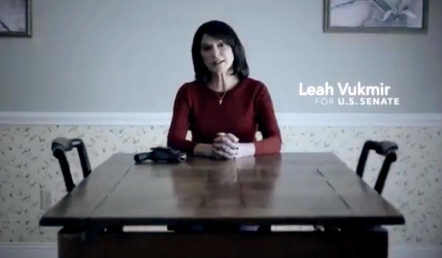 This frame grab from a video provided by the Leah for Senate campaign, shows Leah Vukmir, a Wisconsin Republican U.S. Senate candidate, sitting at a kitchen table with a handgun next to her as she talks about death threats she received. Vukmir&#x27;s ad Monday, June 18, 2018, is the first from a Republican candidate in the primary. She&#x27;s running against Delafield management consultant Kevin Nicholson. The winner will face Democratic Sen. Tammy Baldwin. (Leah for Senate campaign via AP)