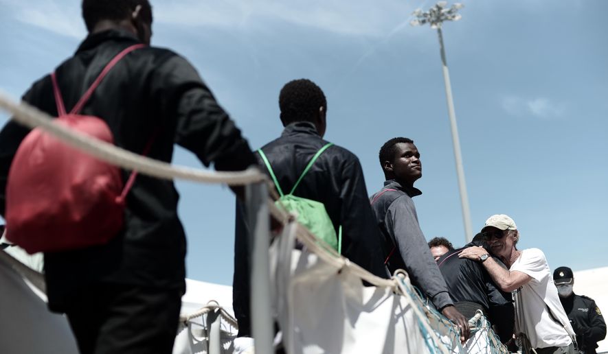 This photo released on Sunday, June 17, 2018, by French NGO &amp;quot;SOS Mediterranee&amp;quot;, shows migrants disembarking the SOS Mediterranee&#x27;s Aquarius ship and MSF (Doctors Without Borders) NGOs, after its arrival at the eastern port of Valencia, Spain. Ships in the Aquarius aid convoy docked Sunday at the Spanish port of Valencia, ending a week long ordeal for hundreds of people who were rescued from the perilous Mediterranean only to become the latest pawn in Europe&#x27;s battle over immigration. (Kenny Karpov/SOS Mediterranee via AP)