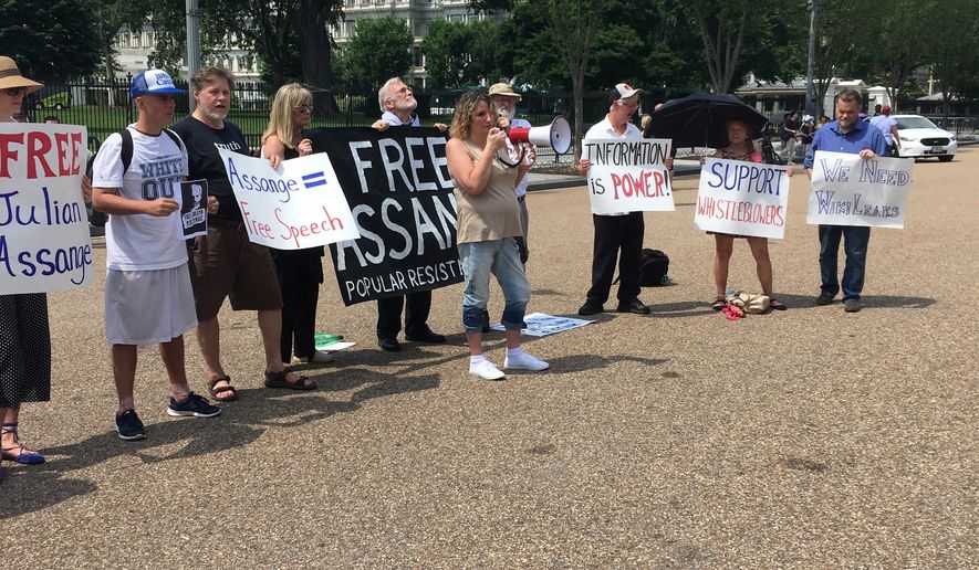 Demonstrators gather outside the White House on Tuesday morning to demand President Trump pardon WikiLeaks founder Julian Assange. (Photos by Connor Foarde)