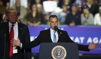 FILE - In this April 28, 2018 file photo, President Donald Trump, left, watches as Corey Lewandowski, right, his former campaign manager for Trump&#39;s presidential campaign, speaks during a campaign rally in Washington Township, Mich. Lewandowski has created a stir by dismissing a story about a girl with Down syndrome with a sarcastic &quot;Wah wah.&quot; Lewandowski appeared Tuesday, June 19, 2018, on Fox News Channel to discuss the president&#39;s hard-line immigration policy, which has led to the practice of taking migrant children from parents charged with entering the country illegally. (AP Photo/Paul Sancya, File)
