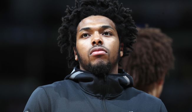 FILE - In this April 1, 2018, file photo, Milwaukee Bucks guard Sterling Brown is seen during an NBA basketball game in Denver. Brown filed a lawsuit Tuesday, June 19, 2018, against the city of Milwaukee and its police department, claiming unlawful arrest and excessive force when officers used a stun gun on him during his arrest in January 2018 for a parking violation. (AP Photo/David Zalubowski, File)