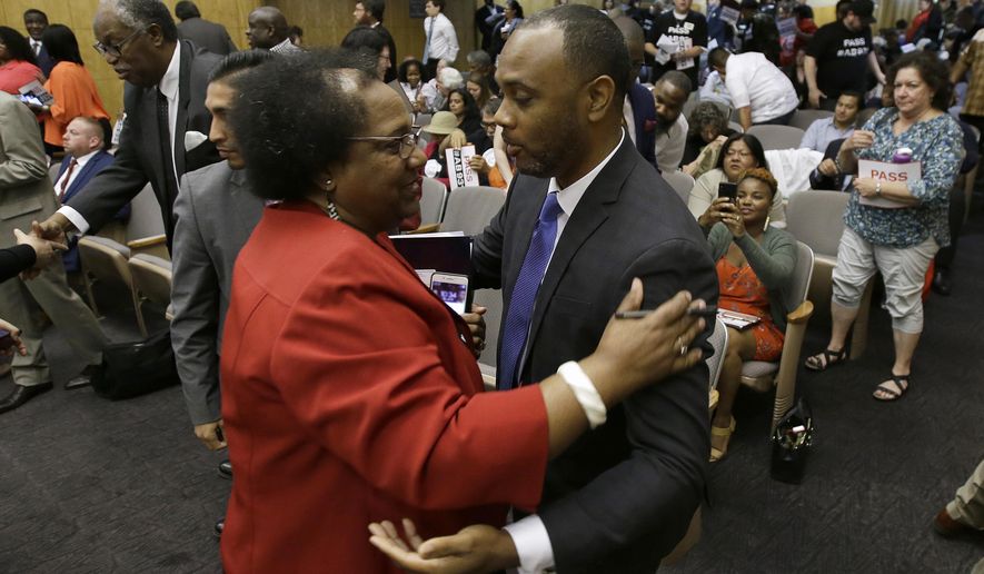 Assemblywoman Shirley Weber, D-San Diego, is congratulated by Pastor Les Simmons after her bill to limit police use of deadly force was approved by the Senate Public Safety Committee, Tuesday, June 19, 2018, in Sacramento, Calif. California senators are advancing a first-in-the-nation bill to significantly change the standards for when police can open fire, acting after an emotion-charged debate over killings that have recently roiled the country. (AP Photo/Rich Pedroncelli)