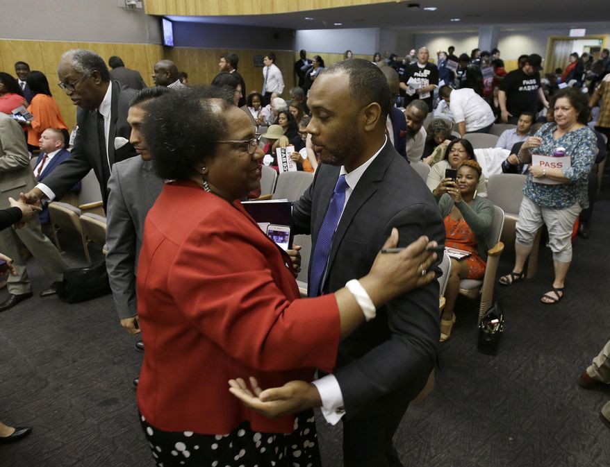 Assemblywoman Shirley Weber, D-San Diego, is congratulated by Pastor Les Simmons after her bill to limit police use of deadly force was approved by the Senate Public Safety Committee, Tuesday, June 19, 2018, in Sacramento, Calif. California senators are advancing a first-in-the-nation bill to significantly change the standards for when police can open fire, acting after an emotion-charged debate over killings that have recently roiled the country. (AP Photo/Rich Pedroncelli)