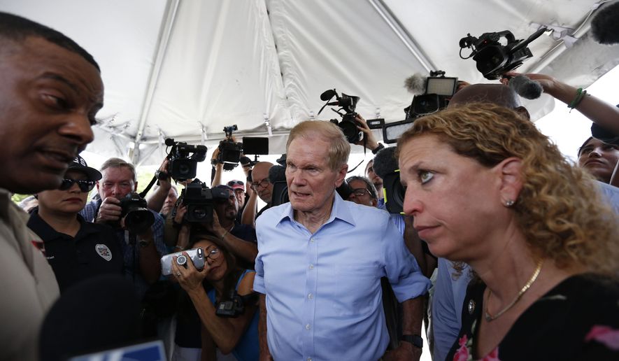 U.S. Sen. Bill Nelson, center and congresswoman Debbie Wasserman Schultz, right, were denied entry by security into the Homestead Temporary Shelter for Unaccompanied Children on Tuesday, June 19, 2018, in Homestead, Fla. (AP Photo/Brynn Anderson)