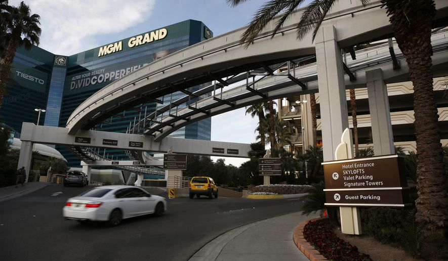 FILE - In this Jan. 14, 2016, photo, cars drive into the MGM Grand hotel and casino in Las Vegas. Thousands of unionized workers at Las Vegas casino-resorts operated by MGM Resorts International are set to approve their newly negotiated five-year contract. The agreement up for a vote Tuesday, June 19, 2018, includes wage increases and stronger protections against sexual harassment for 24,000 bartenders, housekeepers and other members of the Culinary Union. (AP Photo/John Locher, File)