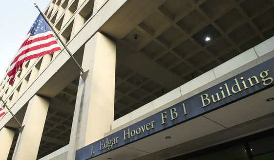 The FBI&#39;s J. Edgar Hoover Headquarters, across the street from the Justice Department in Washington, Wednesday, Nov. 2, 2016. (AP Photo/Cliff Owen)