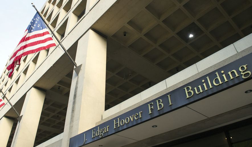 The FBI's J. Edgar Hoover Headquarters, across the street from the Justice Department in Washington, Wednesday, Nov. 2, 2016. (AP Photo/Cliff Owen)