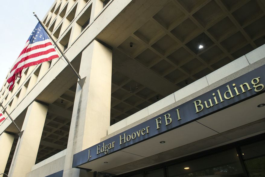 The FBI&#39;s J. Edgar Hoover Headquarters, across the street from the Justice Department in Washington, Wednesday, Nov. 2, 2016. (AP Photo/Cliff Owen)