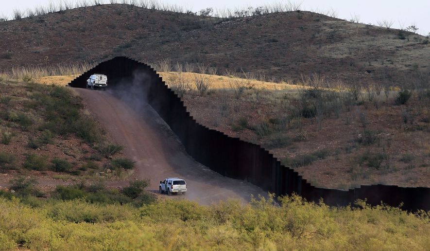 In this Oct. 2, 2012, file photo, U.S. Border Patrol agents patrol the border fence in Naco, Ariz. (AP Photo/Ross D. Franklin, file)