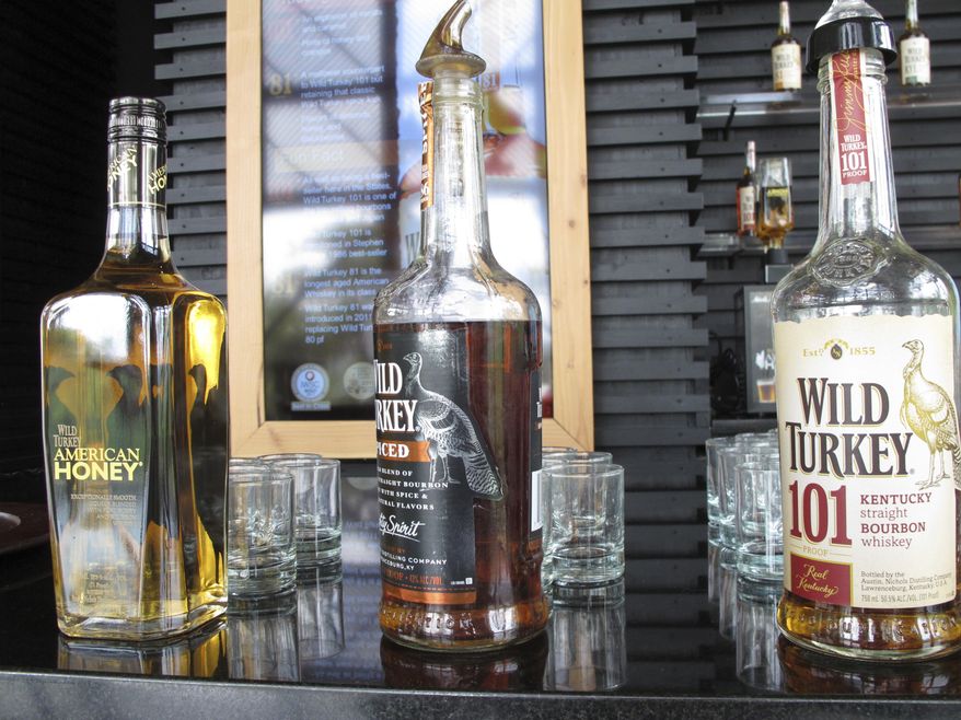 FILE- In this Aug. 22, 2014, file photo, Wild Turkey sampling bottles sit on the bar at the distillery's visitors' center near Lawrenceburg, Ky. The European Union will start taxing on Friday a range of imports from the U.S., including quintessentially American goods like Harley-Davidson bikes and cranberries, in response to President Donald Trump's decision to slap tariffs on European steel and aluminum. The goods targeted include typical American exports, including bourbon, peanut butter, cranberries and orange juice, in a way that seems designed to create the most political pressure on Trump and U.S. politicians. (AP Photo/Bruce Schreiner, File)