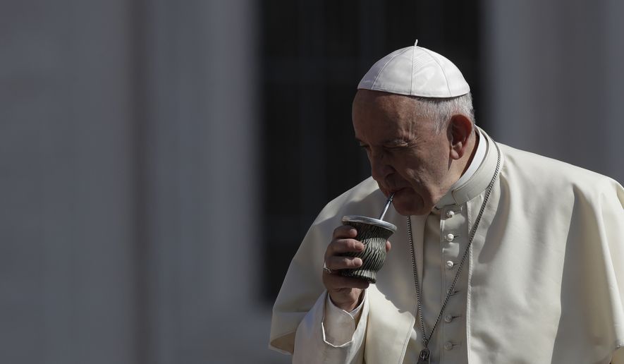 Pope Francis drinks some mate offered by a pilgrim as he arrives in St. Peter&#x27;s Square at the Vatican, for his weekly general audience, Wednesday, June 20, 2018. (AP Photo/Alessandra Tarantino)