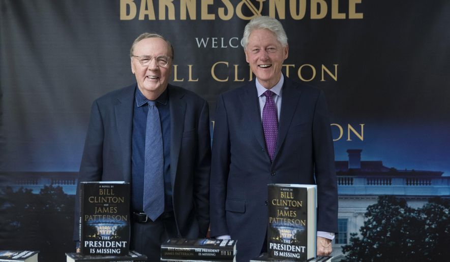 FILE - In this June 5, 2018 file photo, former President Bill Clinton, right, and author James Patterson pose for photographers during an event to promote their new novel, "The President is Missing," in New York. For the second straight week, a thriller co-written by former President Bill Clinton is NPD BookScan’s top seller. The book, co-written by James Patterson, tells of a president trying to prevent a devastating cyberattack. BookScan announced Wednesday that it sold 121,300 copies last week, just a slight drop from its opening week of 152,000. (AP Photo/Mary Altaffer, File)