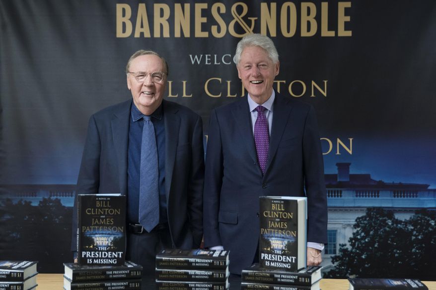 FILE - In this June 5, 2018 file photo, former President Bill Clinton, right, and author James Patterson pose for photographers during an event to promote their new novel, "The President is Missing," in New York. For the second straight week, a thriller co-written by former President Bill Clinton is NPD BookScan’s top seller. The book, co-written by James Patterson, tells of a president trying to prevent a devastating cyberattack. BookScan announced Wednesday that it sold 121,300 copies last week, just a slight drop from its opening week of 152,000. (AP Photo/Mary Altaffer, File)