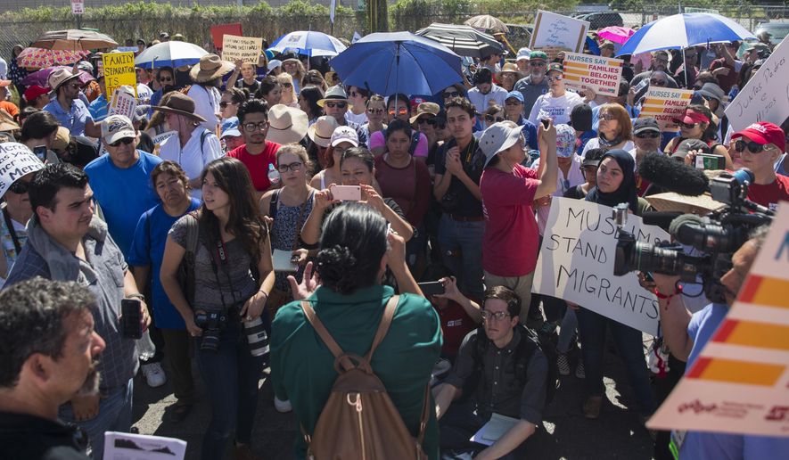 Protesters stand outside the U.S. Immigration and Customs Enforcement processing center in El Paso, Texas, Tuesday, June 19, 2018. (Ivan Pierre Aguirre/The San Antonio Express-News via AP)