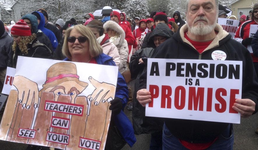 FILE - In a March 21, 2018 file photo, Debbie Burke, left, an elementary school teacher in Pike County, and her husband Gary Burke rally against a proposed pension overhaul bill, in Frankfort, Ky. Franklin County, Ky.,  Circuit Judge Phillip Shepherd on Wednesday, June 20, 2018 ruled that the process the Republican-led legislature used to enact the law violated the state Constitution. (AP Photo/Bruce Schreiner, File)