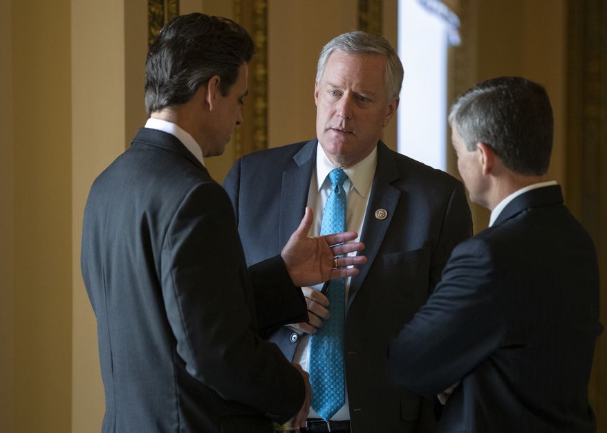 Rep. Mark Meadows, R-N.C., center, chairman of the conservative House Freedom Caucus, flanked by Rep. Tom Graves, R-Ga., Rep. Jeb Hensarling, R-Texas, talk before a series of votes in the House, at the Capitol in Washington, Thursday, June 21, 2018. Yesterday, Rep. Meadows and Speaker of the House Paul Ryan, R-Wis., faced off in the chamber as lawmakers struggled to move on immigration amid the political fallout of migrant families being separated at the border. (AP Photo/J. Scott Applewhite)