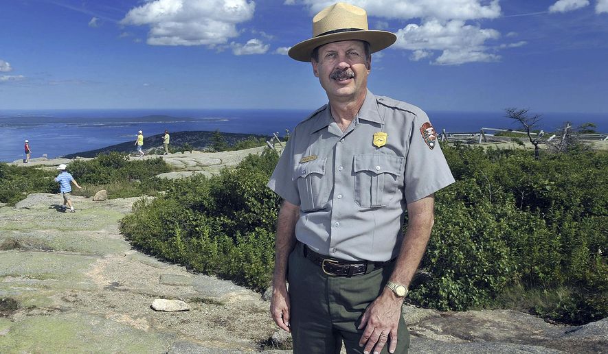 FILE - In this July 30, 2008 file photo, Acadia National Park Superintendent Sheridan Steele poses atop Cadillac Mountain at Bar Harbor, Maine. An Interior Department investigation made public on Thursday, June 21, 2018, faulted Steele for illegally accepting a family vacation to the U.S. Virgin Islands from officials with a nonprofit group that received federal funding, just months before he retired in 2015. (AP Photo/Michael C. York, File)