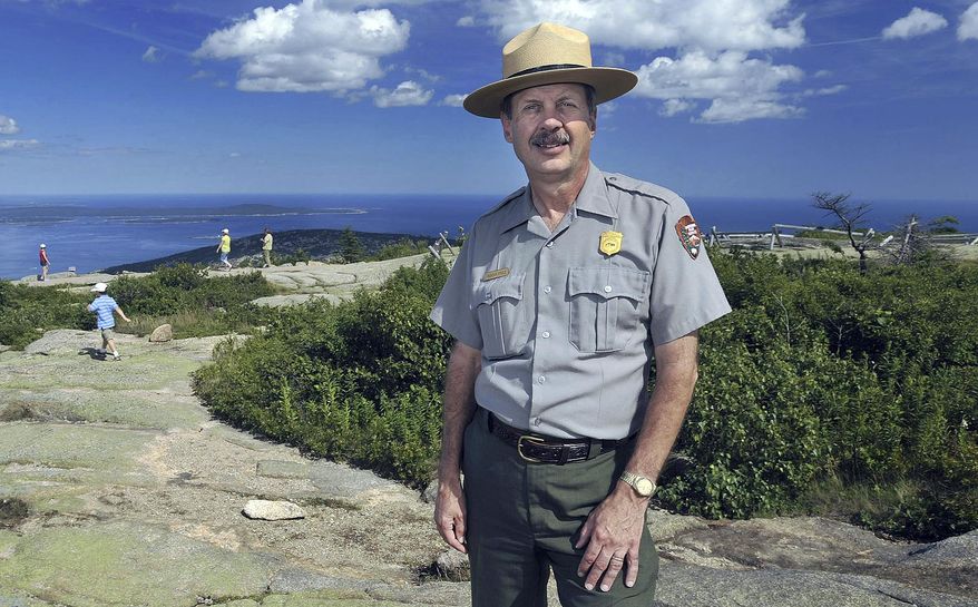 FILE - In this July 30, 2008 file photo, Acadia National Park Superintendent Sheridan Steele poses atop Cadillac Mountain at Bar Harbor, Maine. An Interior Department investigation made public on Thursday, June 21, 2018, faulted Steele for illegally accepting a family vacation to the U.S. Virgin Islands from officials with a nonprofit group that received federal funding, just months before he retired in 2015. (AP Photo/Michael C. York, File)