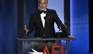 FILE - In this June 7, 2018 file photo, actor-director George Clooney accepts the 46th AFI Life Achievement Award in Los Angeles. The American Film Institute hosted a star-studded gala earlier this month to honor the Oscar-winner’s achievements as an actor, director and activist. TNT is airing the gala on Thursday at 10 p.m. Eastern and Pacific. (Photo by Chris Pizzello/Invision/AP, File)