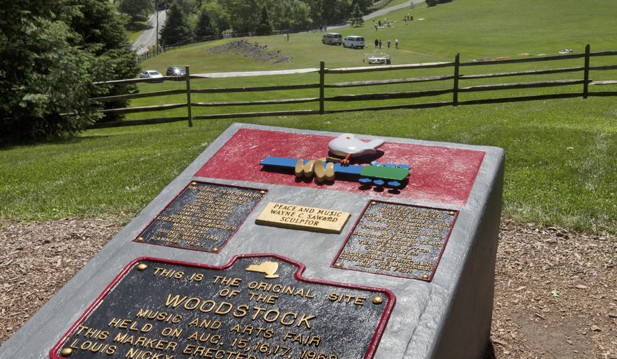 In this June 14, 2018, photo, members of the Public Archaeology Facility at Binghamton University work at the site of the 1969 original Woodstock Music and Art Fair, in Bethel, N.Y. Information from the dig will help a museum plan interpretive walking routes in time for the concert’s 50th anniversary next year. (AP Photo/Richard Drew)