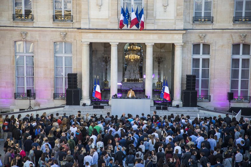 DJ Chloe mixes tracks during the country's Music Day at the Elysee Palace in Paris, Thursday, June 21, 2018. The French presidency host an unprecedented electronic music show in the elegant courtyard of the Elysee Palace on the country's Music Day. (Christophe Petit Tesson/Pool Photo via AP)