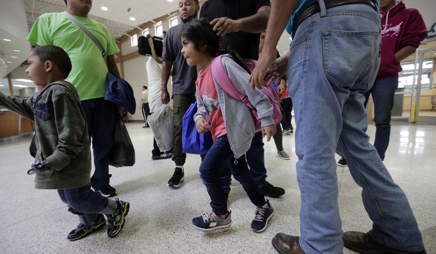 A group of immigrants from Honduras and Guatemala seeking asylum arrive at the bus station after they were processed and released by U.S. Customs and Border Protection, Thursday, June 21, 2018, in McAllen, Texas. President Donald Trump signed an executive order to end family separations at the border. (AP Photo/Eric Gay)