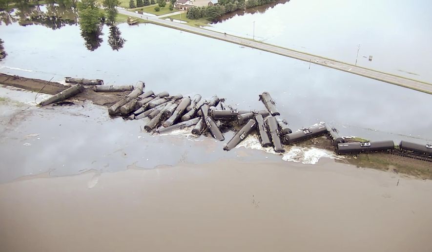In this aerial drone image taken from video and provided by the Sioux County Sheriff&#x27;s Office, tanker cars carrying crude oil are shown derailed about a mile south of Doon, Iowa, Friday, June 22, 2018. About 31 cars derailed after the tracks reportedly collapsed due to saturation from flood waters from adjacent Little Rock River. (Sioux County Sheriff&#x27;s Office via AP)