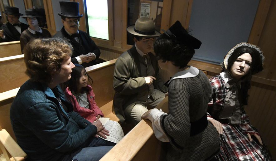 In this June 14, 2018 photo, Mia Tonaki sits with her grandmother Laura Lestina as they visit the train car area of the Fiery Trial exhibit at the Civil War Museum in Kenosha, Wis. (Sean Krajacic /The Kenosha News via AP)