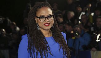 FILE - In this March 13, 2018 file photo, director Ava DuVernay appears at the premiere of &amp;quot;A Wrinkle In Time,&amp;quot; in London.  DuVernay has checked off another milestone for black female directors. This week her film “A Wrinkle in Time” crossed the $100 million mark domestically, a first for a black woman. (Photo by Joel C Ryan/Invision/AP, File)