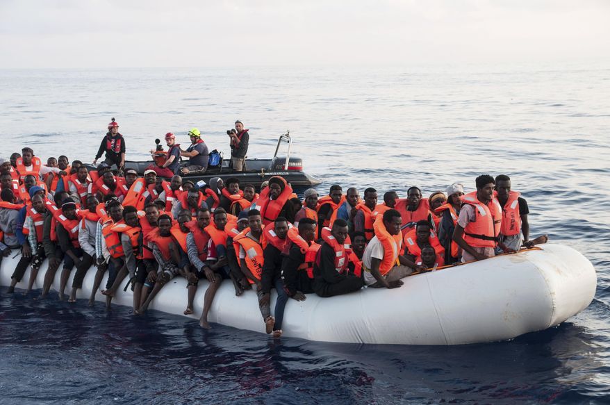 In this photo taken on Thursday, June 21, 2018, migrants on a rubber boat are being rescued by the ship operated by the German NGO Mission Lifeline in the Mediterranean Sea in front of the Libyan coast. Italy&#x27;s interior minister says Malta should allow a Dutch-flagged rescue ship carrying 224 migrants to make port there because the ship is now in Maltese waters. Salvini said the rescue was in Libyan waters, which Lifeline denies. (Hermine Poschmann/Mission Lifeline via AP)