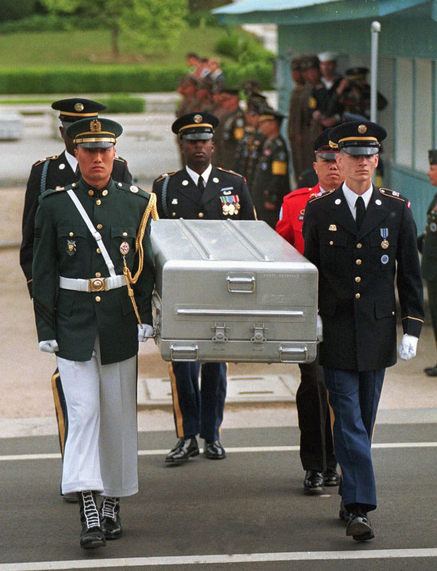 FILE- In this May 14, 1999, file photo, U.N. honor guards carry a coffin containing the remains of the American soldiers after it was returned from North Korea at the border village of Panmunjom, South Korea. South Korean media reported that the U.S. military plans to send 215 caskets to North Korea through a border village on Saturday, June 23, 2018, so that the North could begin the process of returning the remains of U.S. soldiers who have been missing since the 1950-53 Korean War. (AP Photo/Ahn Young-joon, File)