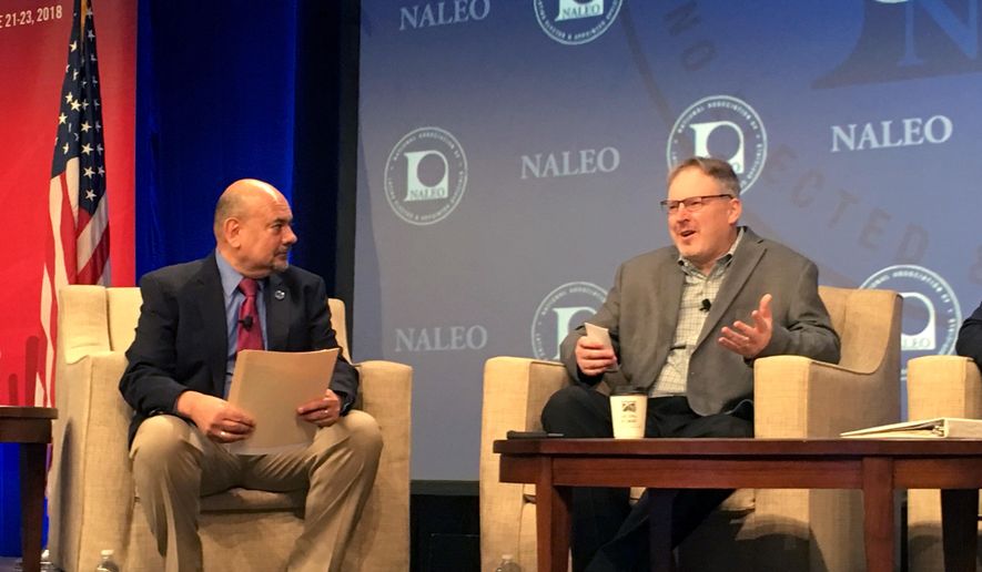 Arturo Vargas, executive director of the National Association of Latino Elected and Appointed Officials, left, speaks with U.S. Census Bureau Acting Director Ron Jarmin about plans to add a question about citizenship to the 2020 questionnaire, Saturday, June 23, 2018, in Phoenix. The group opposes the question and says it’s politically driven and will result in an undercount of Latinos in the nation. (AP Photo/Astrid Galvan)