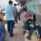 CORRECTS DATE TO JUNE 21, NOT 23 - In this Thursday, June 21, 2018 photo, migrant families rest from their travels to Matamoros, Mexico, along Gateway International Bridge which connects to Brownsville, Texas, as they seek asylum in the United States. (Miguel Roberts/The Brownsville Herald via AP)