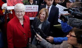 In this Nov. 15, 2016, file photo, Barronelle Stutzman, left, a Richland, Wash., florist, smiles as she is surrounded by supporters after a hearing in Bellevue, Wash. (AP Photo/Elaine Thompson, File)