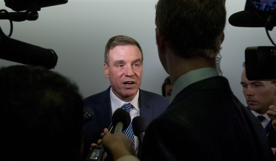 Sen. Mark Warner, D-Va., speaks to reporters on Capitol Hill in Washington, Tuesday, Oct. 31, 2017, on the Muller investigation indictments. (AP Photo/Andrew Harnik)