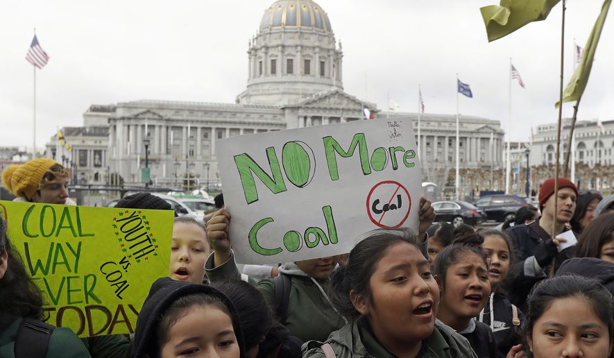 In this Feb. 28, 2018, file photo, students rally for clean energy in front of San Francisco City Hall. (AP Photo/Jeff Chiu, File)