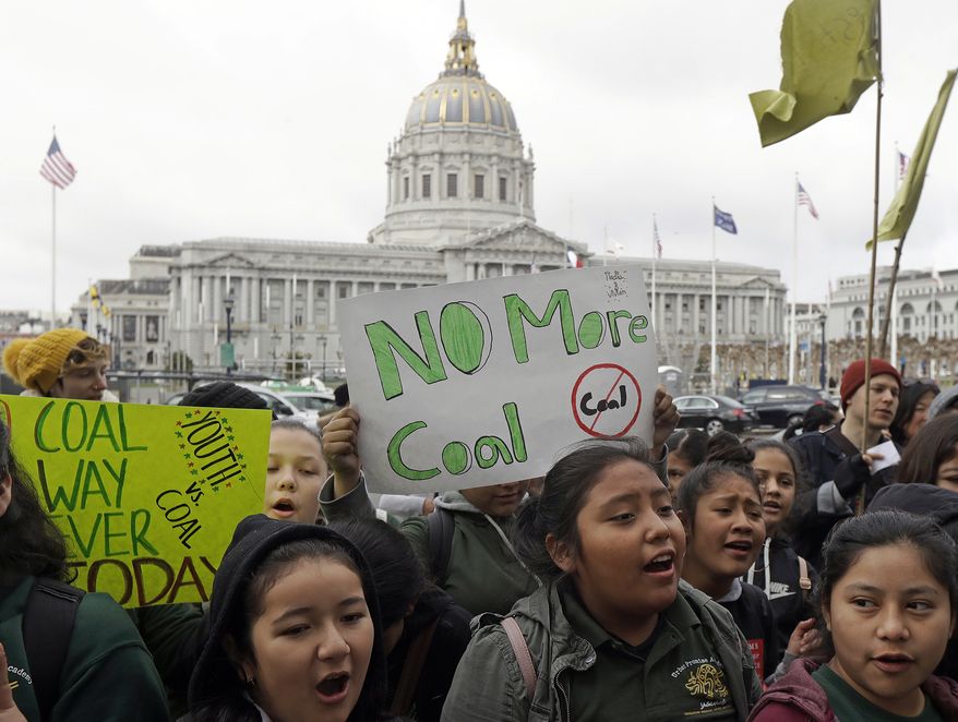 In this Feb. 28, 2018, file photo, students rally for clean energy in front of San Francisco City Hall. (AP Photo/Jeff Chiu, File)