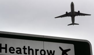 FILE - In this file photo dated Tuesday, June 5, 2018, a plane takes off over a road sign near Heathrow Airport in London.  British lawmakers are set to vote Monday June 25, 2018, on whether to expand Europe&#39;s biggest airport, Heathrow. (AP Photo/Kirsty Wigglesworth, FILE)