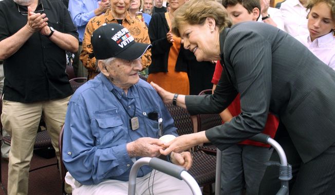 Retired Army Capt. Martin Gelb is presented with the Congressional Gold Medal by U.S. Sen. Jeanne Shaheen, D-N.H., on Monday, June 25, 2018, in Derry, New Hampshire. Gelb, 98, was honored for his World War II service with the Office of Strategic Services, the precursor to the Central Intelligence Agency. (AP Photo/Holly Ramer)