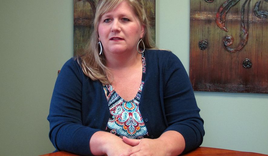 Staci Jones poses for a photo at her lawyer's office on Friday, June 22, 2018 in Collierville, Tenn. Advocates for domestic violence victims are praising a new Tennessee law that seeks to stop a common tactic that batterers use after their victims have fled to safety: Filing frivolous lawsuits designed to bankrupt or inflict more harm on the people they already have abused. Jones, teaches English as a second language and said she probably owes more than $100,000 from ongoing legal battles with a man she hoped to never see again.(AP Photo/Adrian Sainz)