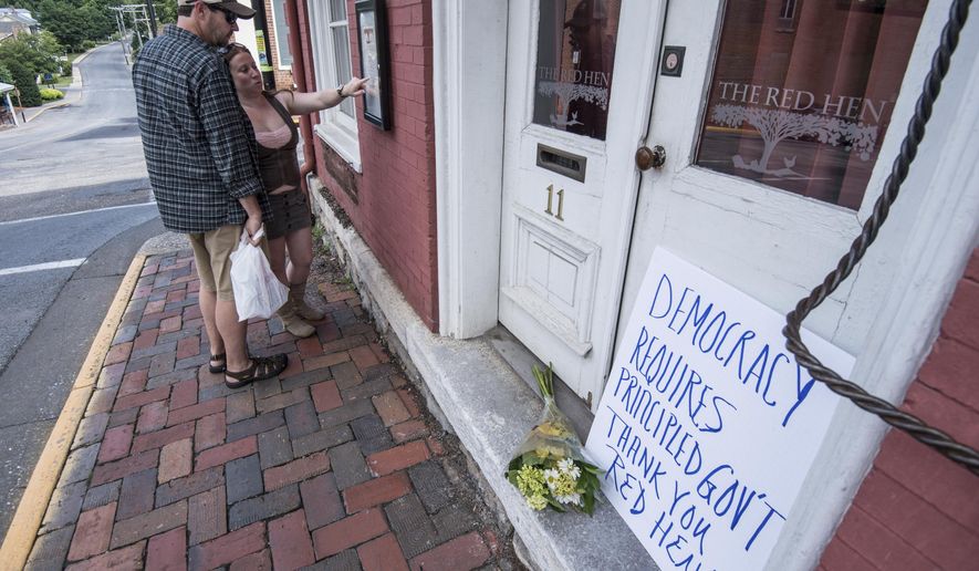 Passersby examine the menu at the Red Hen Restaurant Saturday, June 23, 2018, in Lexington, Va. White House press secretary Sarah Huckabee Sanders said Saturday in a tweet that she was booted from the Virginia restaurant because she works for President Donald Trump. Sanders said she was told by the owner of The Red Hen that she had to &amp;quot;leave because I work for @POTUS and I politely left.&amp;quot; (AP Photo/Daniel Lin)/Daily News-Record via AP)