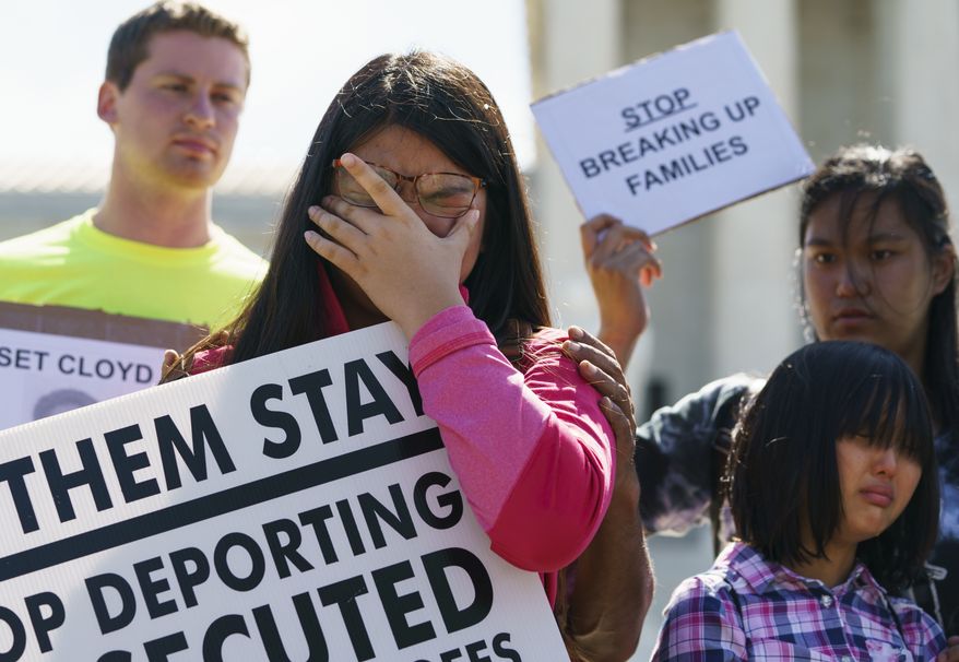 Caitlin Sanger, of Franklin Park, N.J., pauses to cry outside the Supreme Court in Washington, Tuesday, June 26, 2018, as she speaks about her father being detained by ICE and protests immigrant families being split up. Naomi Liem, 10, of Franklin Park, N.J., cries lower right and Jocelyn Pangemanan of Highland Park, N.J., stands right. (AP Photo/Carolyn Kaster)